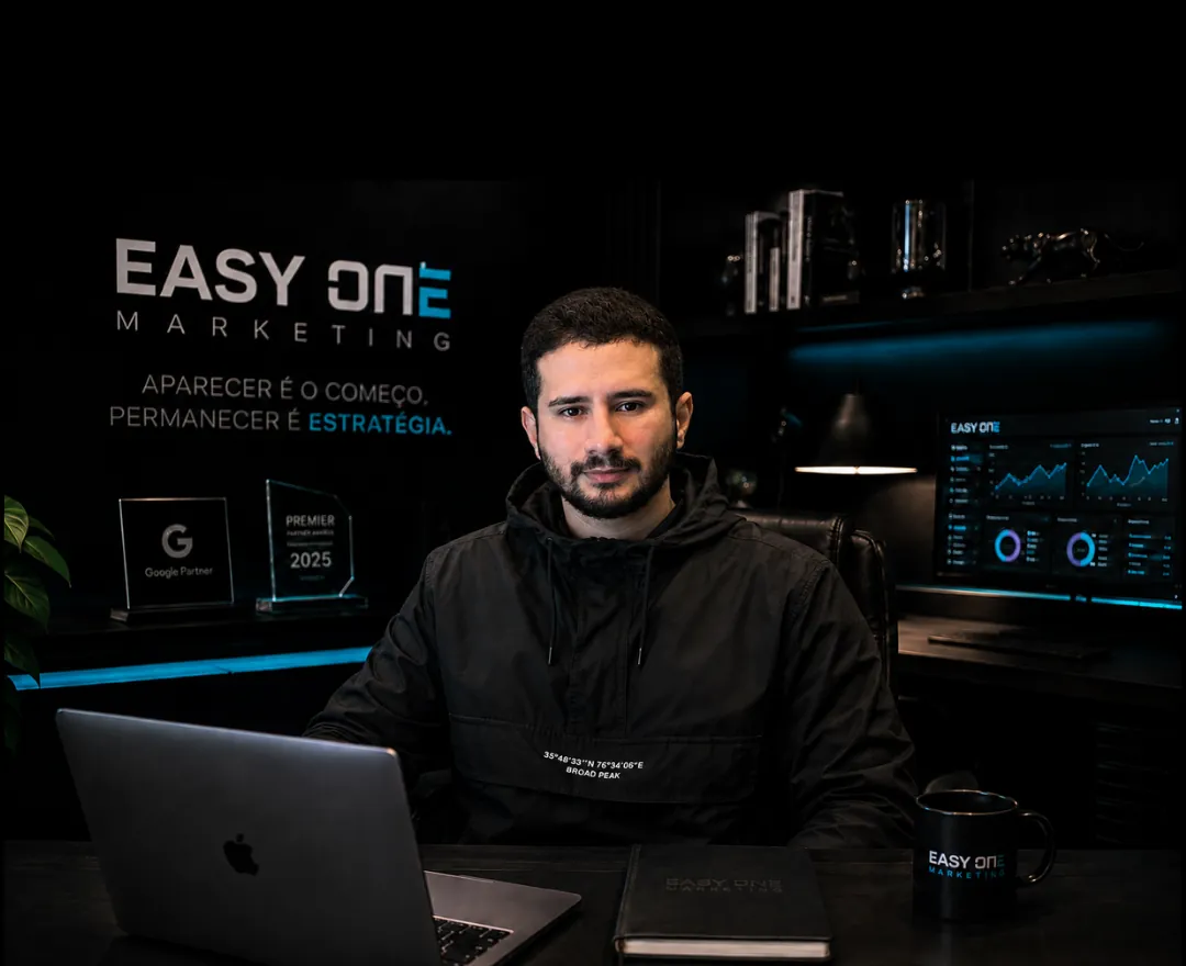 Lucas Oliveira Castro at the Easy One Marketing studio, with the company logo and the Google Partner plaque behind him